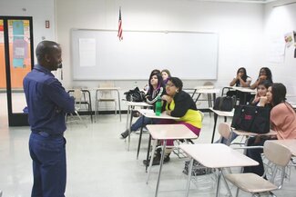 Grad. students Mbhekiseni Madela & Rebecca Vaughn attended Global Fest 2012 in Bloomington, Il. Pictured: Mbhekiseni teaching Zulu greetings at Normal Community West High School. Global Fest in the Press: http://www.pantagraph.com/news/local/students-get-