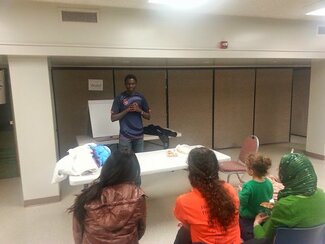 Mor Gueye, Ph.D. student, presents a workshop on Wolof at A Taste of Language, International Week at Illinois