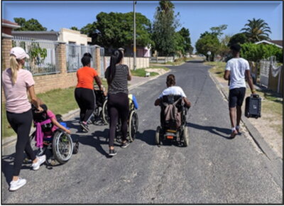 Workers at Sive Nathi take children for a neighborhood stroll.